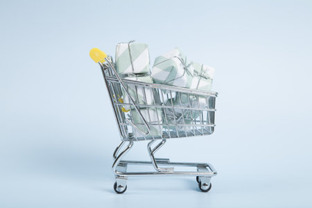 a caddy filled with gifts against a luminous sky-blue background. Minimalist, trendy still life photography.の写真素材