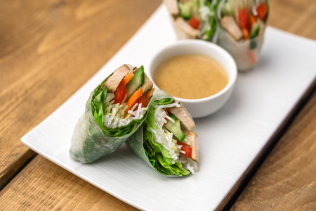 Fresh vietnamese spring rolls, great as an healthy appetizer with peanut butter sauce for dipping.の写真素材