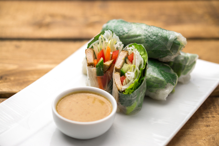 Fresh vietnamese spring rolls, great as an healthy appetizer with peanut butter sauce for dipping.の写真素材