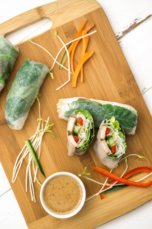 Fresh vietnamese spring rolls, great as an healthy appetizer with peanut butter sauce for dipping.の写真素材