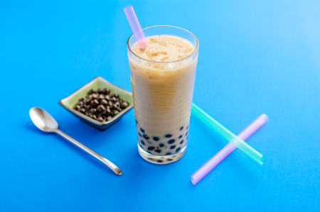 A glass of homemade milk tea bubbletea, with ice and tapioca balls (also called pearls). Bubble tea is a refreshing drink,  very popular in taiwan and increasingly elsewhere in the world.の写真素材