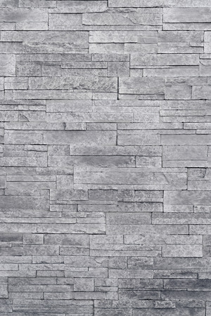 Stone veneer tiles stacked flat make beautiful & modern accent walls in interior design. Use this gray texture as wallpaper, background, backdrop and more!の写真素材