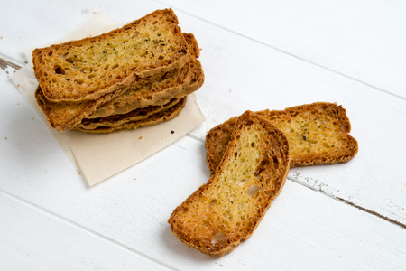 Crostini without toppings on a white background. A crostino is a small slice of toasted or grilled bread used in Italian cuisine for appetizers. Itâs an healthy food, a versatile snack to eat just plain, with vegetables, cheeses or meats!の写真素材
