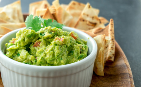 Guacamole close-up view. Guacamole is a avocado based dip, traditionally a mexican (Aztecs) dish. Healthy and easy to make at home with a few simple ingredients. Excellent as party food or at bars..の写真素材