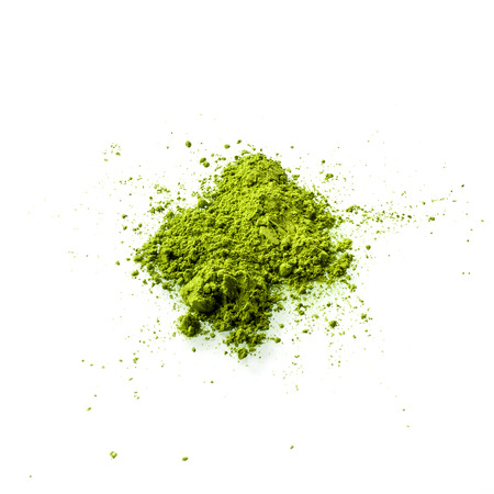 Matcha green tea powder on white background flat view. Matcha is made of finely ground green tea powder. It's very common in japanese culture. Matcha is healthy due to it's high antioxydant count.の写真素材