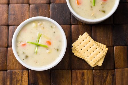 Clam chowder from above. Traditionally from the United States, New England Clam Chowder is a delicious type of hearty and creamy soup. It commonly made with clams, potatoes, onions and celery.の写真素材