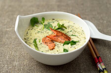 Tom kha asian coconut soup bowl. One of the most popular Thai food, tom kha is a spicy and sour soup with coconut milk. Vermicelli noodles and salmon are added in this version of the dish.の写真素材