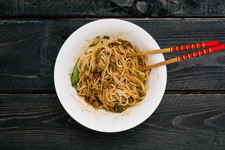 Dan Dan Chinese Noodles. Dan Dan Noodles is a spicy Szechuan cuisine dish commonly found in chinese street food. Ingredients include thick rice noodles, sichuan pepper, chili oil and ground pork.の写真素材