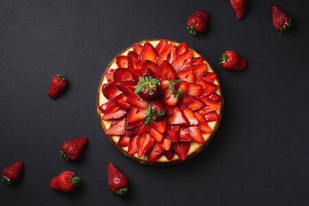 Strawberry Cheesecake top view from above. A classic decadent dessert, this sweet and delicious homemade baked cheesecake is topped with fresh strawberry slices. The perfect cake for a birthday!の写真素材