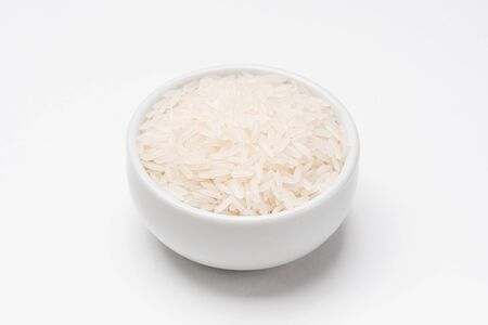 Jasmine rice bowl on white background. Rice comes from seeds of grass, it is the most consumed staple food ingredient. Jasmine rice is a type of fragant long grain rice often used in chinese cuisine.の写真素材