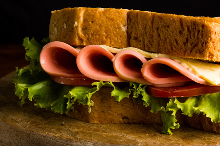 Sandwich ham cheese, whole grain bread, organic salad, cheese, fresh tamato and hamの写真素材