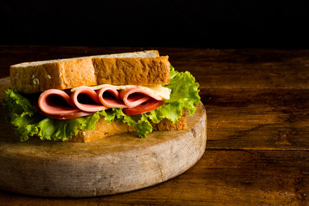 Sandwich ham cheese, whole grain bread, organic salad, cheese, fresh tamato and hamの写真素材