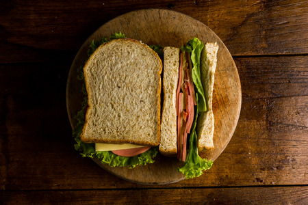 Sandwich ham cheese, whole grain bread, organic salad, cheese, fresh tamato and ham