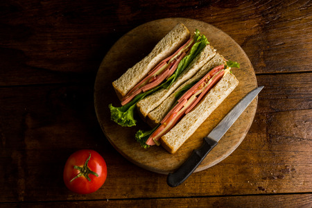 Sandwich ham cheese, whole grain bread, organic salad, cheese, fresh tamato and hamの写真素材