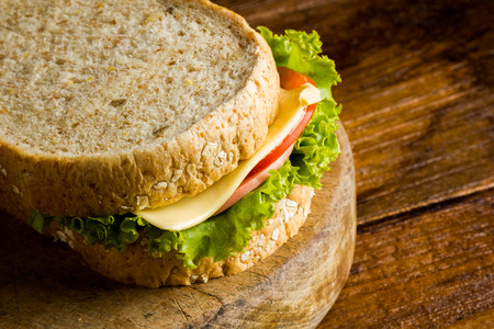 Sandwich ham cheese, whole grain bread, organic salad, cheese, fresh tamato and hamの写真素材