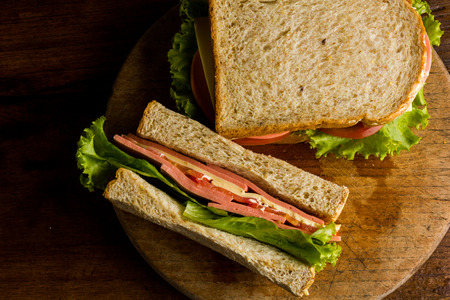 Sandwich ham cheese, whole grain bread, organic salad, cheese, fresh tamato and hamの写真素材