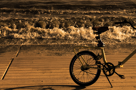 Vintage seascape bicycle with sepia effectの写真素材