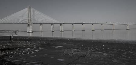 Low tide day in lisbon under the Vasco da Gama bridge. Black and white photosの写真素材