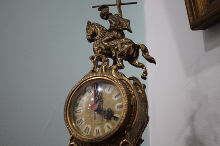 antique metal clock with engravings and horseの写真素材