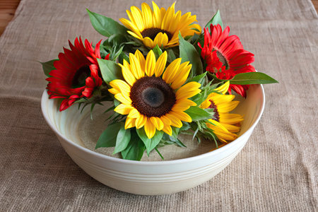 Bouquet of sunflowers in a bowl on sackcloth backgroundの素材
