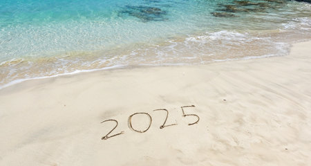 Year 2025 written on the beach with turquoise water. Holiday conceptの写真素材