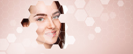 Young sensual woman face shows up from mosaic honeycombs background. Over beige background.の写真素材