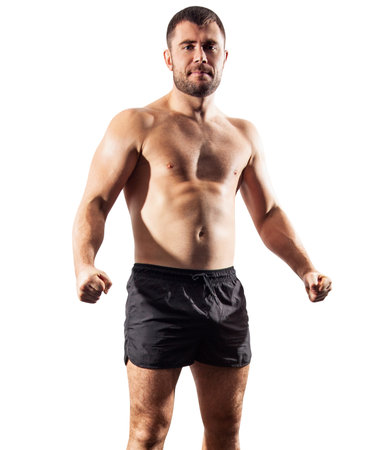 Brutal muscular sportsman standing in black shorts. Over white background.の写真素材