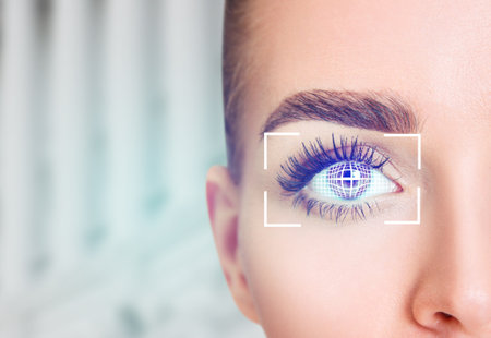 Female eye in digital biometric scanning. Over blue background.の写真素材