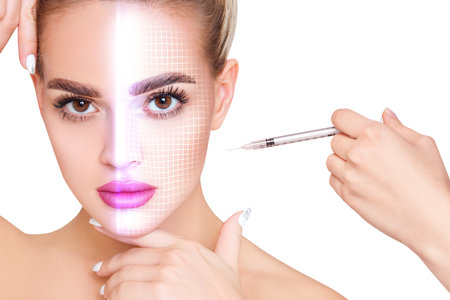 Woman with glowing grid on face has an injection on cheekbone. Anti-wrinkles injections concept.の写真素材