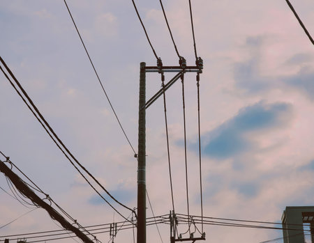 Utility pole and power lines against a cloudy evening sky