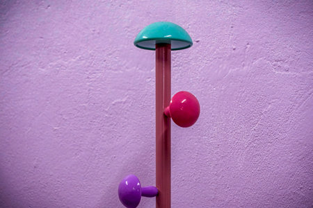 Colorful modern coat rack with turquoise, pink, and purple knobs