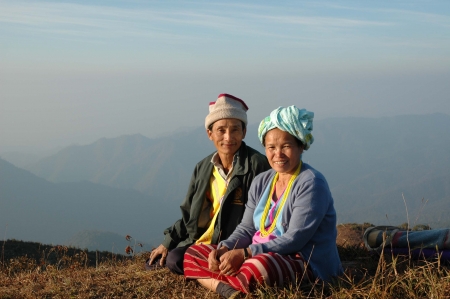 Mae Hong Son, Thailand - December 26, 2006  A Karen couple in casual dress is sitting side by side, relaxing after long hike onto the top of Doi Pui, a mountain near Baan Huay Hee village in Mae Hong Son, northern Thailand のeditorial素材