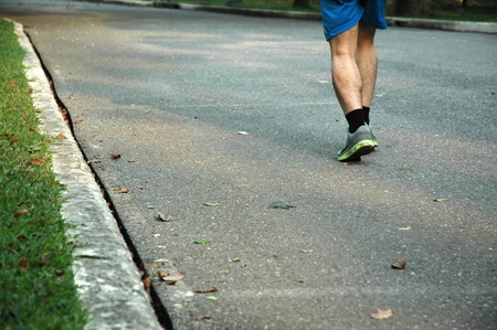 Moving Legs of a Man Jogging in a Gardenの写真素材