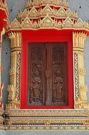 Thai Traditional Style Carved Wooden Window and Stuccoworkの写真素材