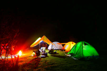Comping tent at night in the forest.
