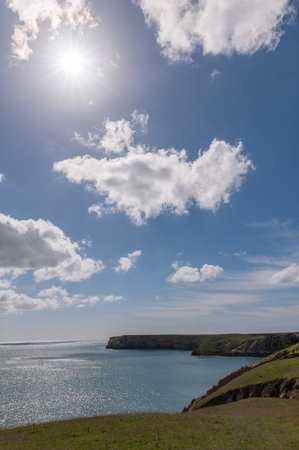Welsh coast line with blue sky and sunの写真素材