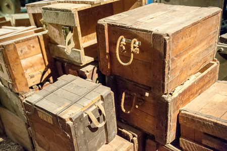 Stack of vintage wooden boxes with rope handlesの写真素材
