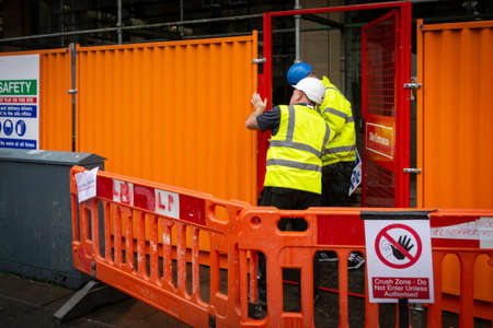 Two builders in safety clothing at a construction site