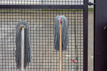 Close-up of mop on a metal fence. House cleaning concept.