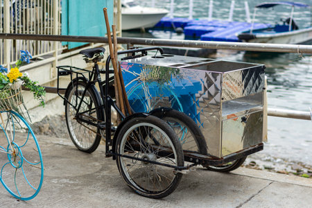 Old tricycle on the quay of Lake Garda, Italy