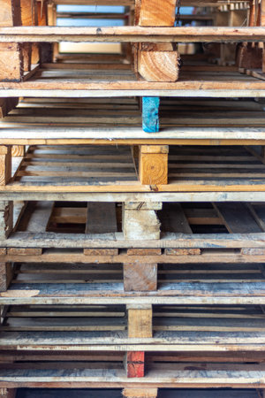 Wooden pallets stacked in a warehouse, closeup of photo