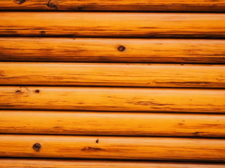 Wooden wall of a log house. Abstract background and texture for design.の素材
