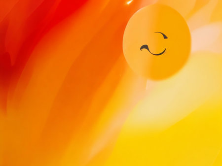 abstract background with a smiley face on a yellow and orange backgroundの素材