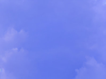 Blue sky background with tiny clouds, soft focus, and copy space.の素材