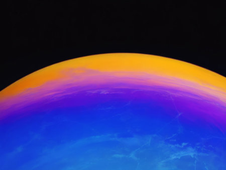 colorful planet on a black background, close up of photo.の素材