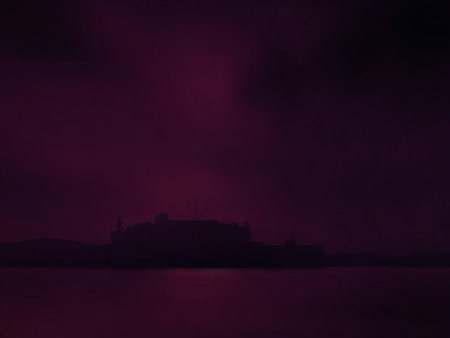 Foggy night on the sea. Silhouette of a building in the fogの素材