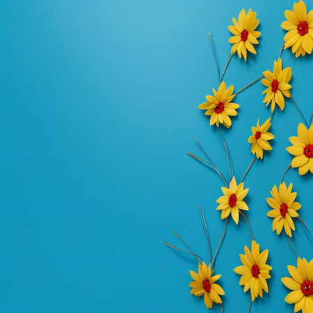 Yellow flowers on blue background. Flat lay, top view, copy spaceの素材