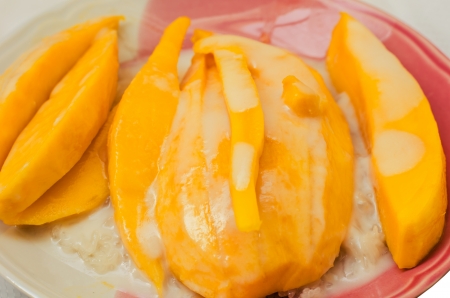Thai style tropical dessert, glutinous rice eat with mangoesの写真素材
