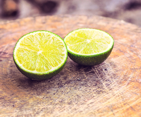 Juicy ripe citrus on an old wooden table - lime, lemonの写真素材