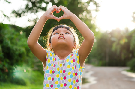 children look pass hand heartの写真素材
